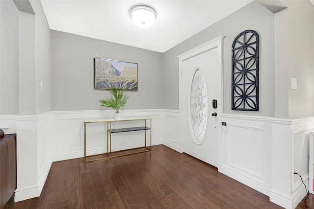 12814 Westmere Dr, Houston, TX 77077 - foyer featuring a decorative wall, wainscoting, and dark wood finished floors