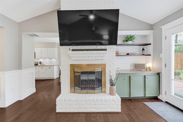 12814 Westmere Dr, Houston, TX 77077 - living area with vaulted ceiling, dark wood finished floors, and a fireplace