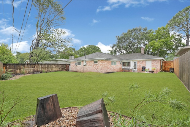 12814 Westmere Dr, Houston, TX 77077 - back of house featuring a chimney, brick siding, a fenced backyard, and roof with shingles