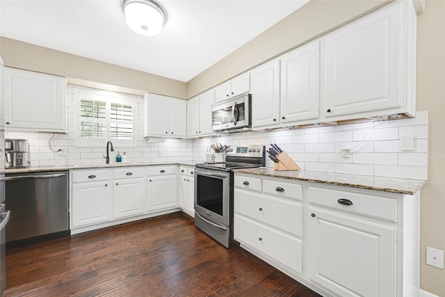 12814 Westmere Dr, Houston, TX 77077 - kitchen featuring stainless steel appliances, light stone countertops, tasteful backsplash, and dark wood finished floors