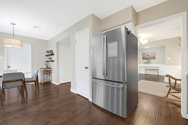 12814 Westmere Dr, Houston, TX 77077 - kitchen with freestanding refrigerator, dark wood-type flooring, a wainscoted wall, and decorative light fixtures