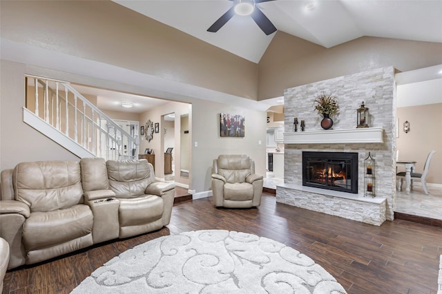 627 S Hyannis Port St, Crosby, TX 77532 - living room featuring a ceiling fan, wood finished floors, a fireplace, stairway, and high vaulted ceiling