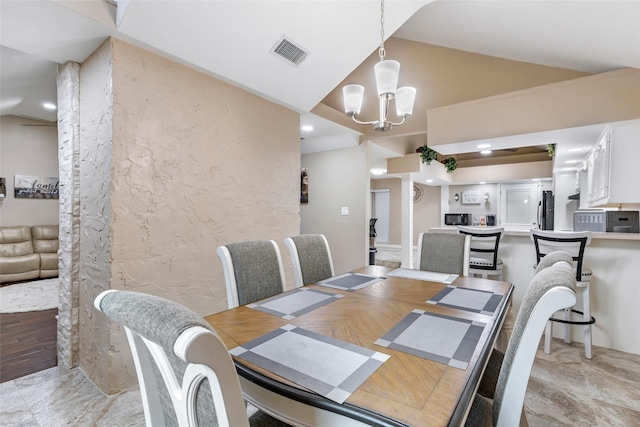 627 S Hyannis Port St, Crosby, TX 77532 - dining room with vaulted ceiling, a chandelier, a textured wall, and recessed lighting