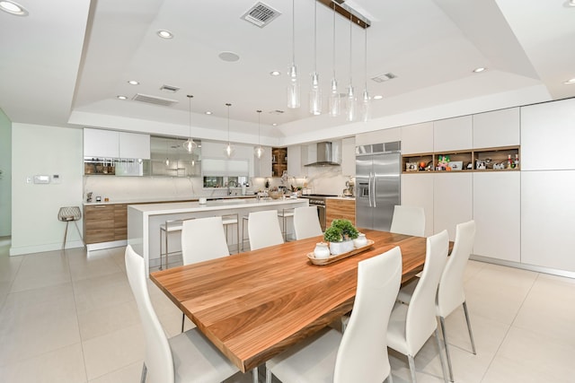 8911 Birdwood Ct, Houston, TX 77096 - dining space featuring a tray ceiling, recessed lighting, and light tile patterned floors