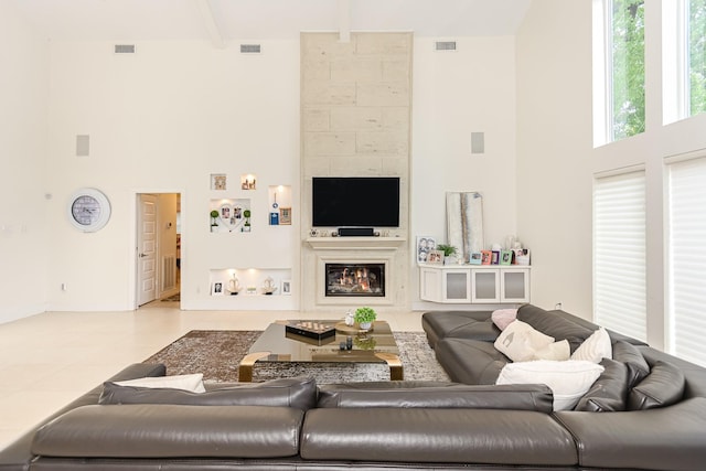 8911 Birdwood Ct, Houston, TX 77096 - living area featuring a towering ceiling, a large fireplace, beam ceiling, and tile patterned floors