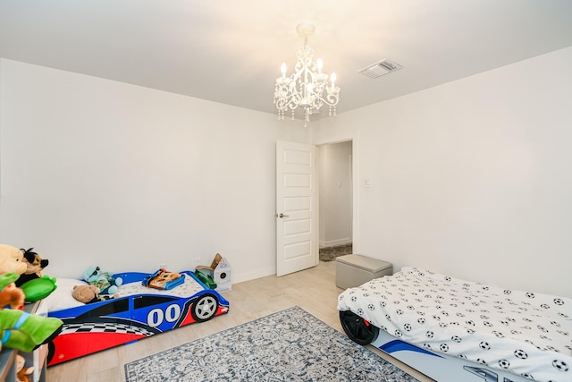 8911 Birdwood Ct, Houston, TX 77096 - bedroom with a chandelier and light wood-style floors