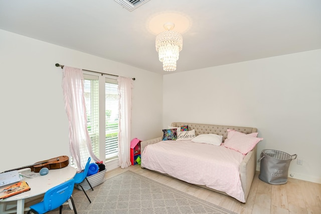 8911 Birdwood Ct, Houston, TX 77096 - bedroom featuring a chandelier and wood finished floors