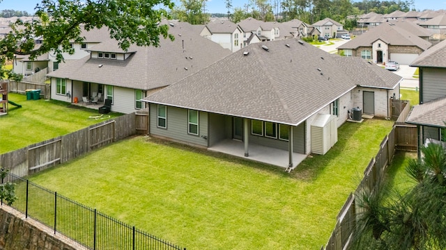 15308 Sandhill Crane Ln, Conroe, TX 77384 - rear view of property featuring a patio area, a shingled roof, a residential view, and a fenced backyard