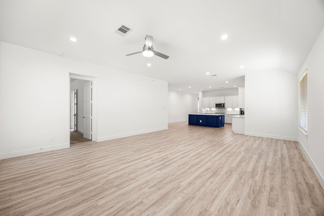 15308 Sandhill Crane Ln, Conroe, TX 77384 - unfurnished living room with light wood-style flooring, recessed lighting, and a ceiling fan