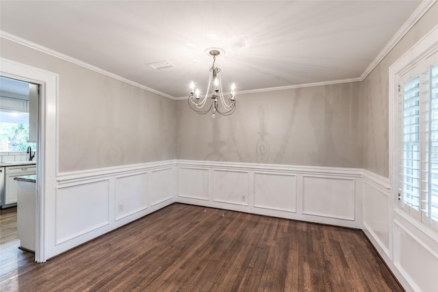 5541 Schumacher Ln, Houston, TX 77056 - unfurnished dining area featuring a chandelier, plenty of natural light, dark wood-style flooring, a decorative wall, and crown molding