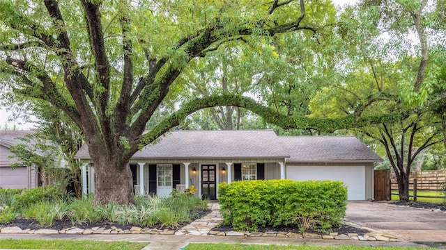 5541 Schumacher Ln, Houston, TX 77056 - ranch-style home with an attached garage, concrete driveway, and a shingled roof