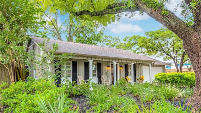 5541 Schumacher Ln, Houston, TX 77056 - view of front of home with covered porch, a garage, and a shingled roof