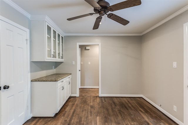 5541 Schumacher Ln, Houston, TX 77056 - kitchen with glass insert cabinets, dark wood-style floors, white cabinets, ceiling fan, and ornamental molding