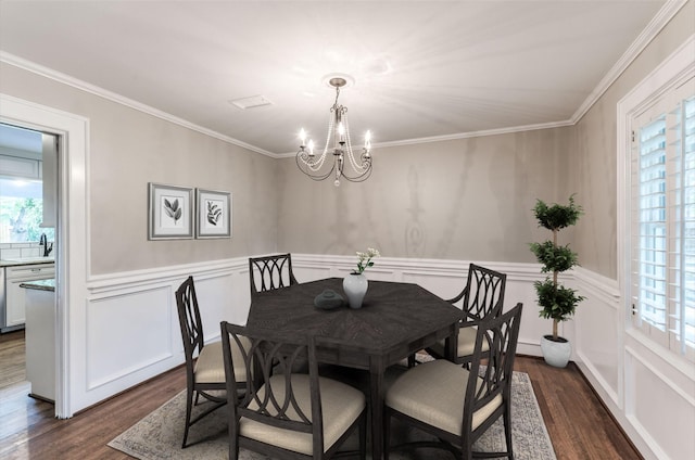 5541 Schumacher Ln, Houston, TX 77056 - dining space with a chandelier, dark wood-style flooring, healthy amount of natural light, a decorative wall, and ornamental molding