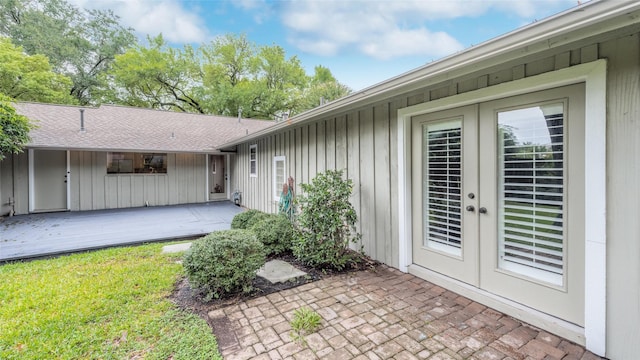 5541 Schumacher Ln, Houston, TX 77056 - entrance to property with french doors, a deck, board and batten siding, and a lawn