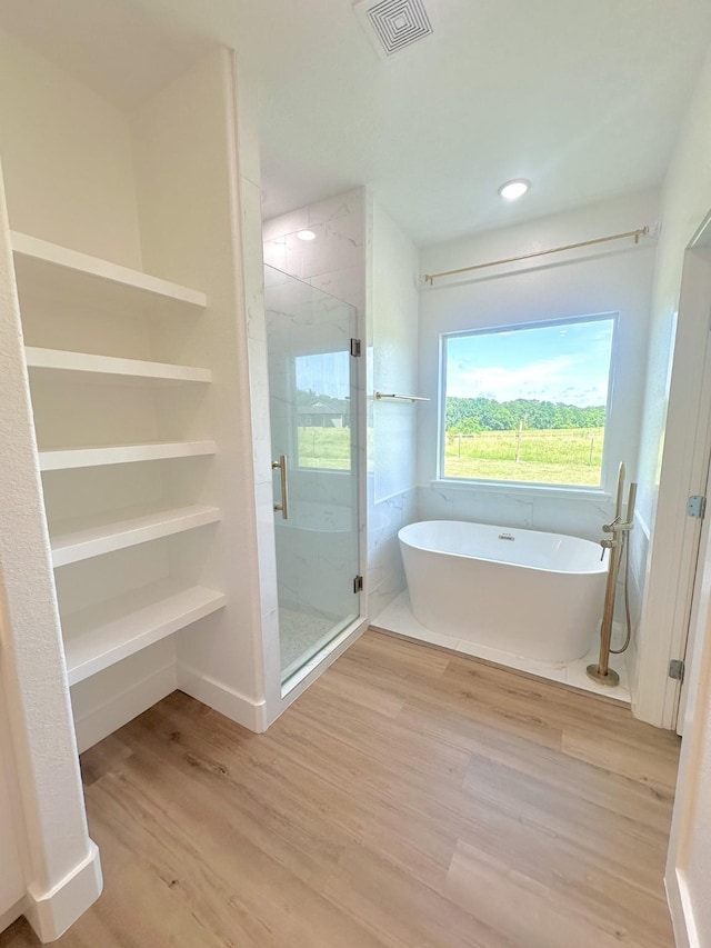 1310 Denson Allen, Coldspring, TX 77331 - full bath with a freestanding tub, wood finished floors, a stall shower, and recessed lighting