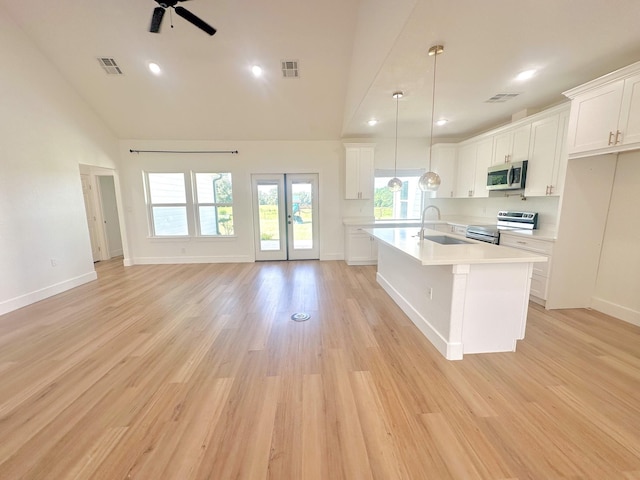 1310 Denson Allen, Coldspring, TX 77331 - kitchen featuring stainless steel appliances, light countertops, a ceiling fan, white cabinets, and french doors