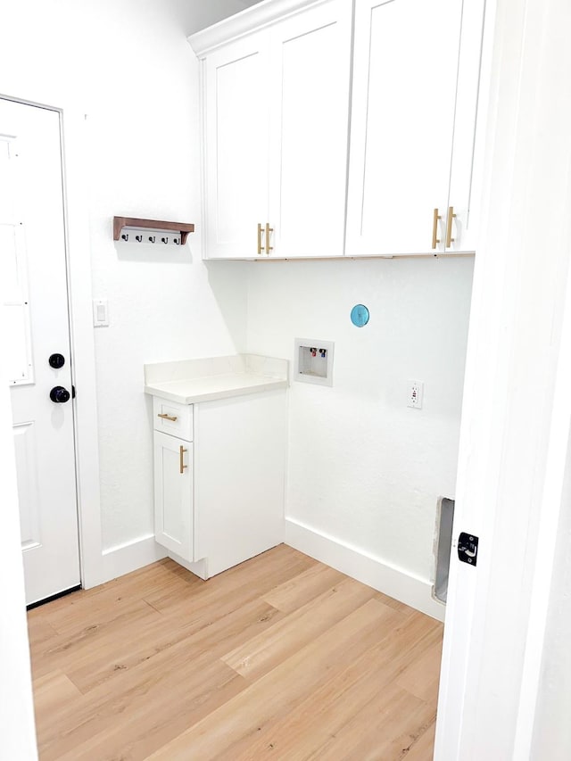 1310 Denson Allen, Coldspring, TX 77331 - washroom featuring light wood-type flooring, cabinet space, and hookup for a washing machine