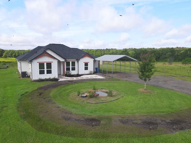 1310 Denson Allen, Coldspring, TX 77331 - rear view of house featuring driveway, a detached carport, board and batten siding, and a shingled roof