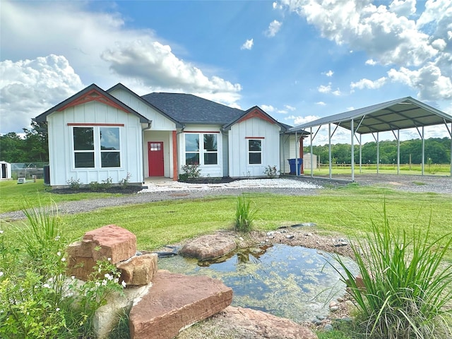 1310 Denson Allen, Coldspring, TX 77331 - view of front of property with board and batten siding, a front lawn, and a garden pond