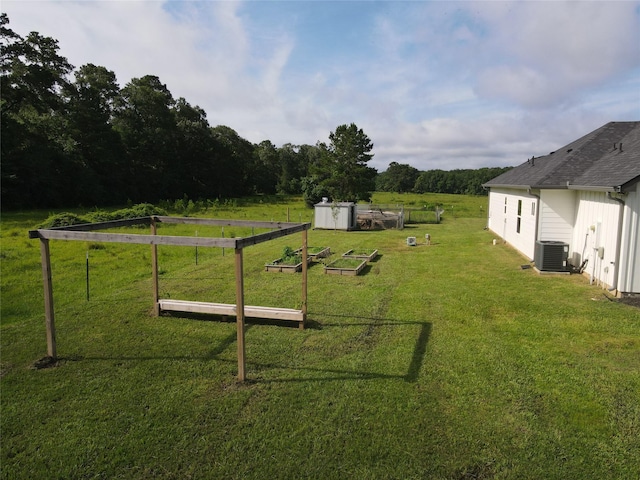 1310 Denson Allen, Coldspring, TX 77331 - view of green lawn featuring a vegetable garden