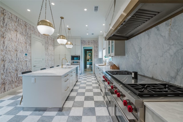 1069 Kirby Dr, Houston, TX 77019 - kitchen with extractor fan, double oven range, white cabinets, and recessed lighting