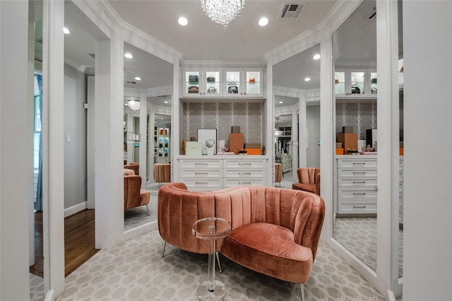 1069 Kirby Dr, Houston, TX 77019 - living area featuring crown molding, recessed lighting, light wood finished floors, and a chandelier