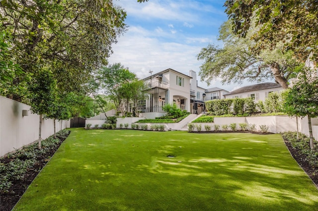1069 Kirby Dr, Houston, TX 77019 - fenced backyard featuring a balcony and stairs