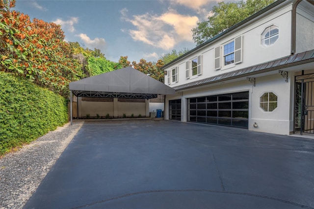 1069 Kirby Dr, Houston, TX 77019 - view of front of property with stucco siding, driveway, and a garage