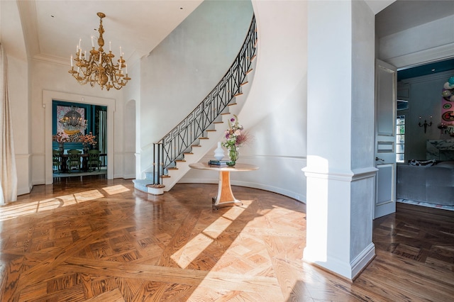1069 Kirby Dr, Houston, TX 77019 - foyer entrance with stairs, a chandelier, a towering ceiling, and ornamental molding