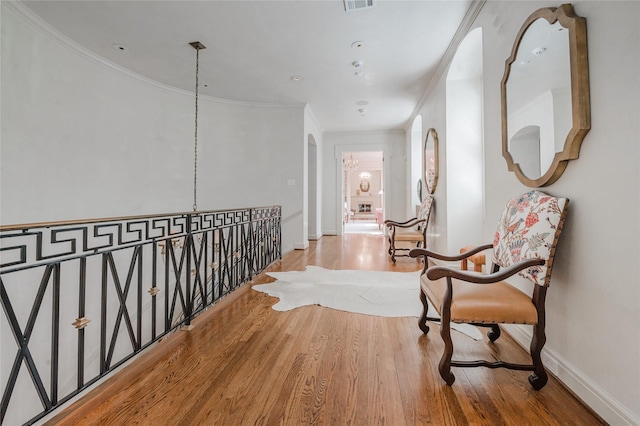 1069 Kirby Dr, Houston, TX 77019 - hallway with crown molding, wood finished floors, and arched walkways