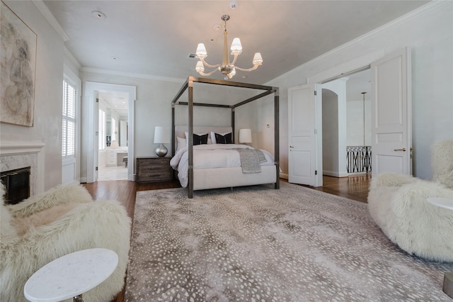 1069 Kirby Dr, Houston, TX 77019 - bedroom with wood finished floors, a chandelier, ornamental molding, a high end fireplace, and ensuite bath