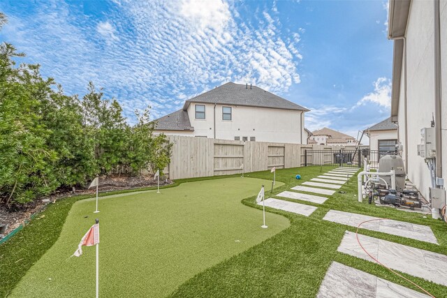 2201 Mulberry Ridge Ct, Manvel, TX 77578 - fenced backyard with a putting area