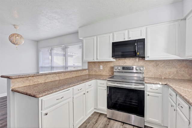 1602 Evesham Dr, Houston, TX 77015 - kitchen featuring black microwave, stainless steel range with electric cooktop, a peninsula, light wood-style flooring, and white cabinetry