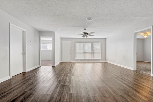 1602 Evesham Dr, Houston, TX 77015 - unfurnished living room featuring ceiling fan, dark wood-style floors, and a textured ceiling
