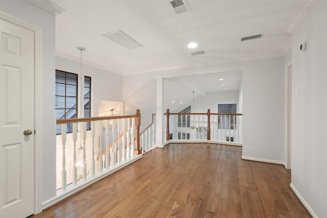 12859 Kingsbridge Ln, Houston, TX 77077 - hall featuring wood finished floors, ornamental molding, an upstairs landing, and recessed lighting
