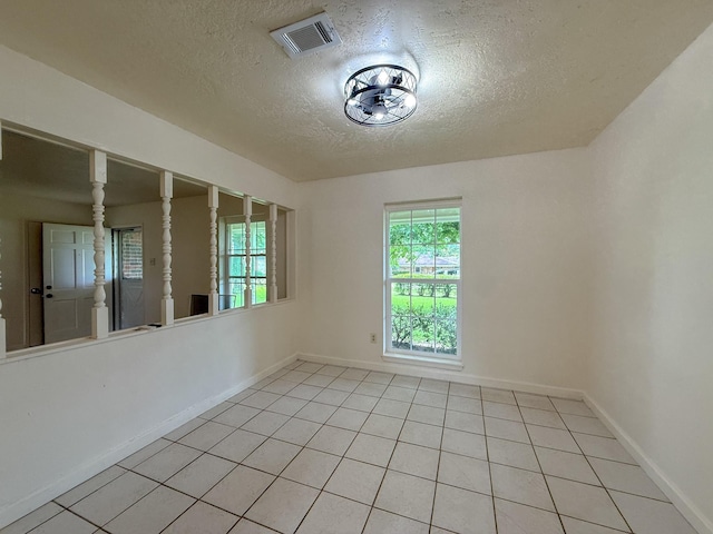 20 Woods Ln, Coldspring, TX 77331 - unfurnished room featuring a textured ceiling and light tile patterned floors