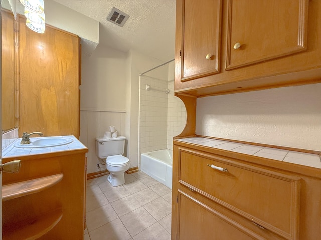 20 Woods Ln, Coldspring, TX 77331 - bathroom with vanity, tile patterned floors, shower / bath combination, a wainscoted wall, and a textured ceiling