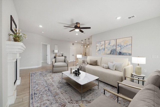 6804 Westview Dr Unit 1407, Houston, TX 77055 - living room featuring ceiling fan, recessed lighting, light wood-type flooring, and a fireplace