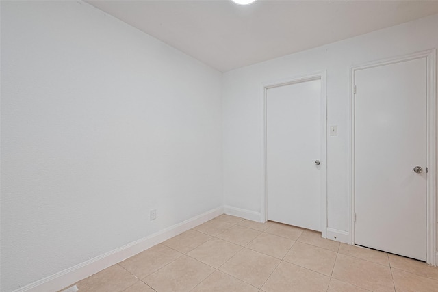 12230 Southmeadow Dr, Stafford, TX 77477 - spare room with light tile patterned floors and baseboards