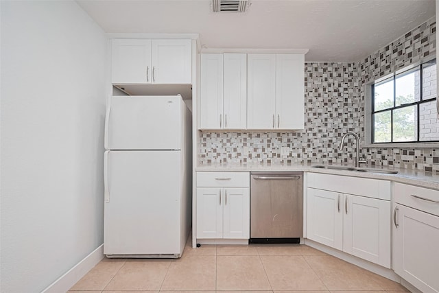 12230 Southmeadow Dr, Stafford, TX 77477 - kitchen featuring freestanding refrigerator, dishwasher, tasteful backsplash, white cabinetry, and light countertops