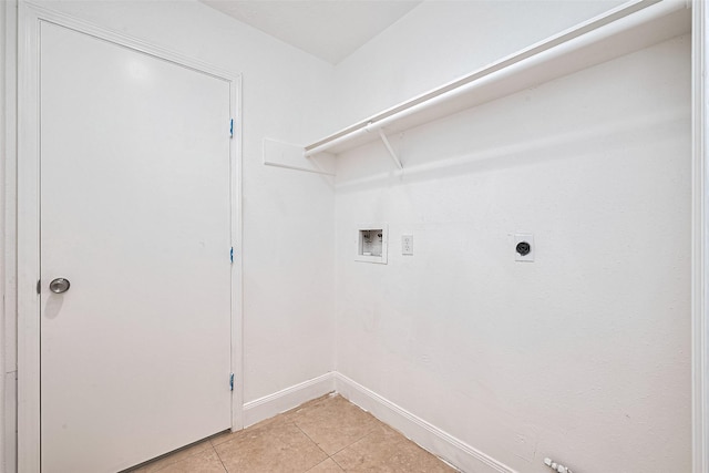 12230 Southmeadow Dr, Stafford, TX 77477 - washroom with hookup for a washing machine, light tile patterned floors, and electric dryer hookup