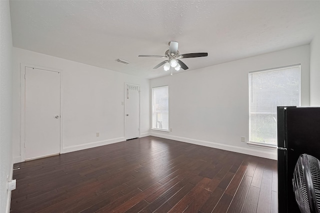 12230 Southmeadow Dr, Stafford, TX 77477 - unfurnished room with ceiling fan, healthy amount of natural light, and dark wood-style floors