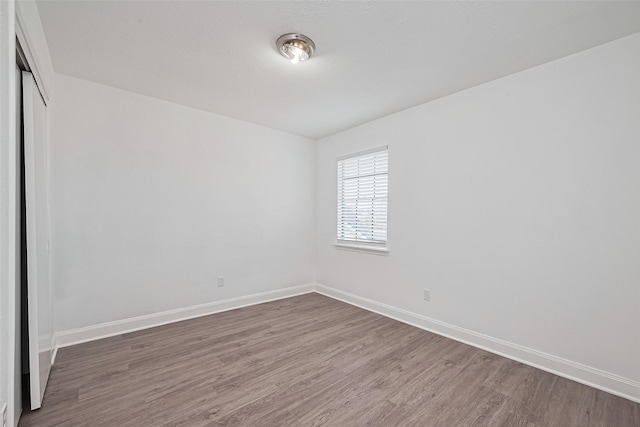 12230 Southmeadow Dr, Stafford, TX 77477 - empty room featuring wood finished floors and baseboards