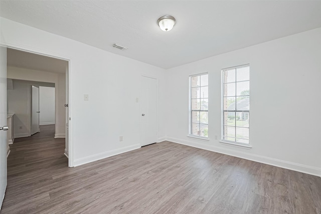 12230 Southmeadow Dr, Stafford, TX 77477 - spare room featuring wood finished floors