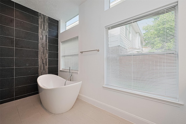 12230 Southmeadow Dr, Stafford, TX 77477 - full bath featuring a freestanding bath and tile patterned floors
