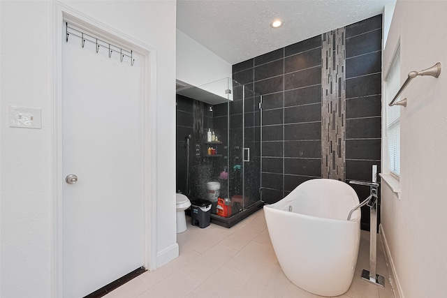 12230 Southmeadow Dr, Stafford, TX 77477 - bathroom featuring tile walls, a freestanding tub, a shower stall, and tile patterned flooring