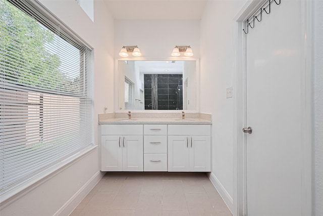 12230 Southmeadow Dr, Stafford, TX 77477 - full bathroom with double vanity, tiled shower, and tile patterned flooring