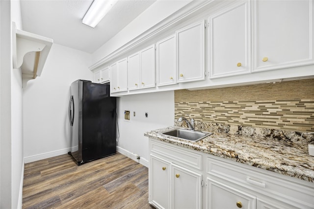 12414 Laneview Dr, Houston, TX 77070 - kitchen with freestanding refrigerator, white cabinets, wood finished floors, backsplash, and light stone countertops