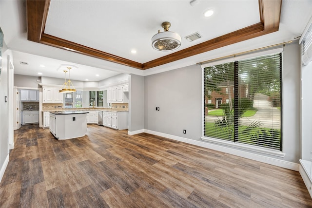 12414 Laneview Dr, Houston, TX 77070 - unfurnished living room featuring a raised ceiling, crown molding, dark wood-type flooring, and recessed lighting